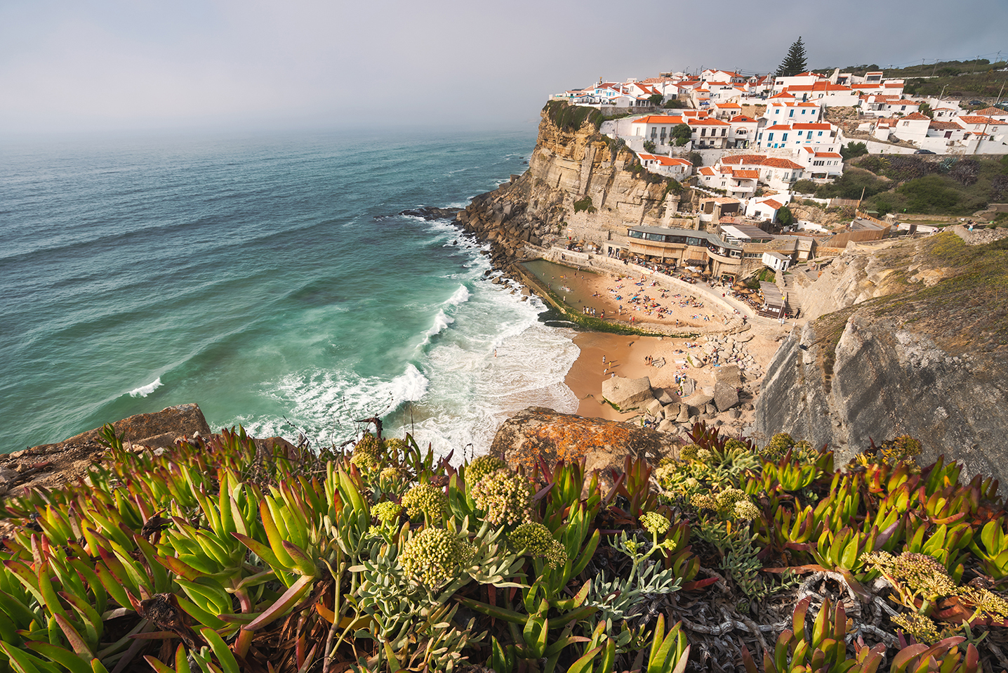 Sintra, Lisbon, Portugal. Azenhas do Mar white village landmark on the cliff and Atlantic ocean waves.